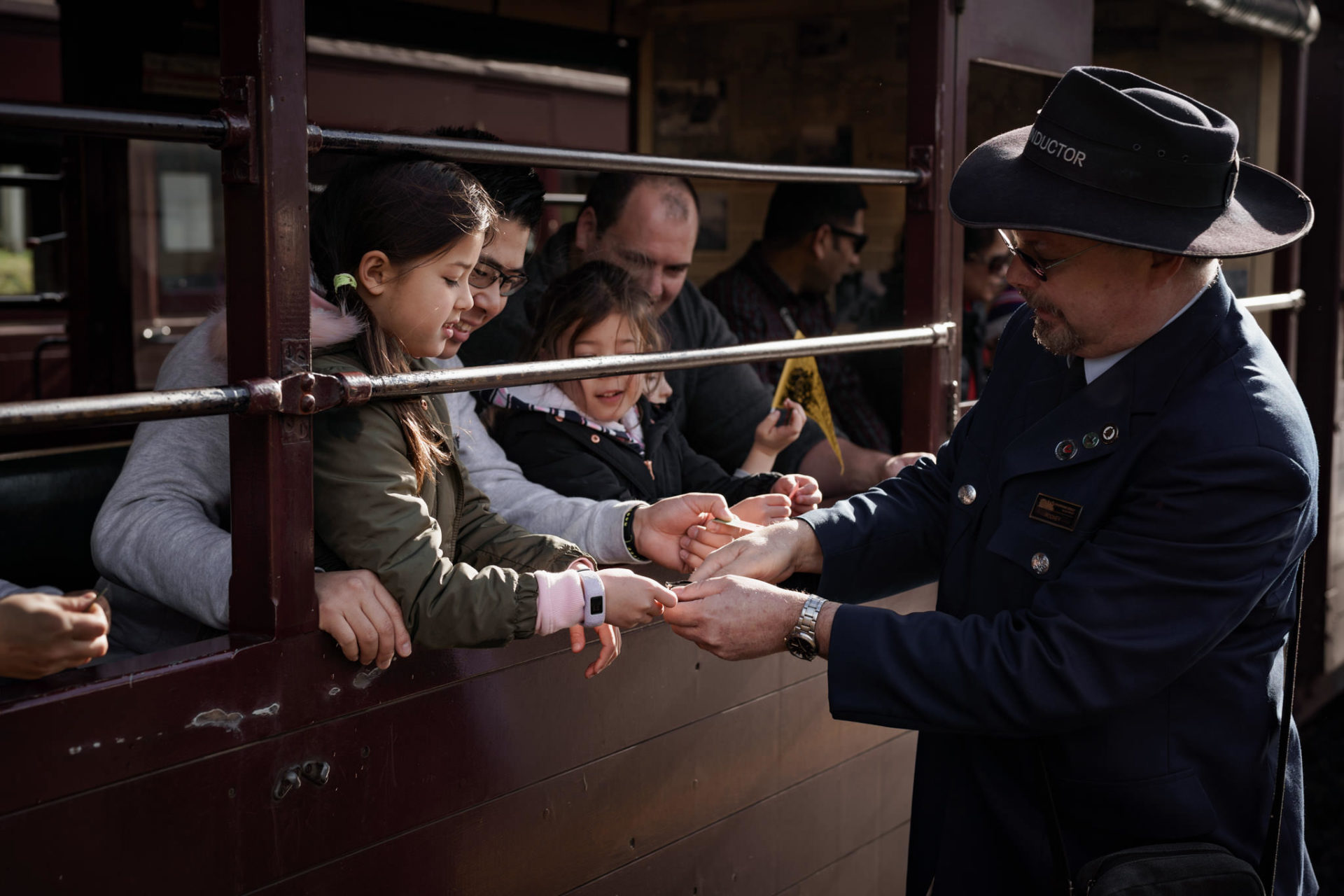 Children Getting Tickets Checked by one of Puffing Billy Railway's conductors.