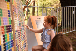 Girl enjoys outdoor imaginative play at Puffing Billy Railway.