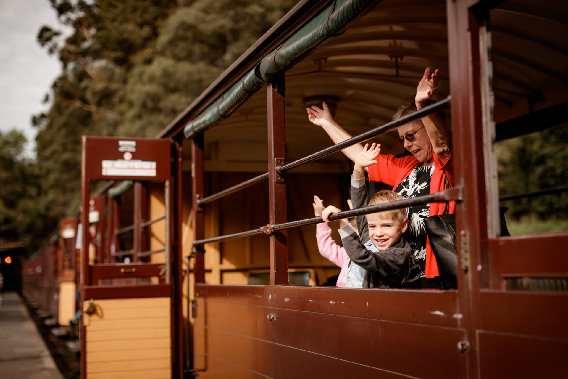 Grandparent And Grandchildren Waving From Carriage Prior To Departure