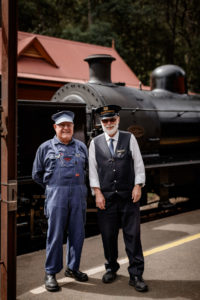 Volunteers Standing Infront Of Locomotive Station Master And Driver