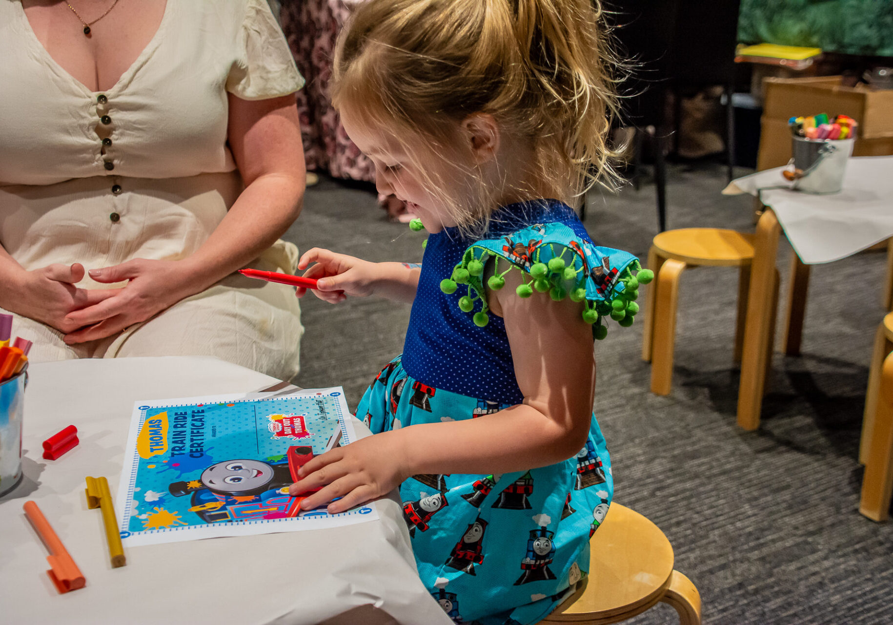 Young Girl Receives Help From Mum To Write Her Name On Her Junior Engineer Certificate