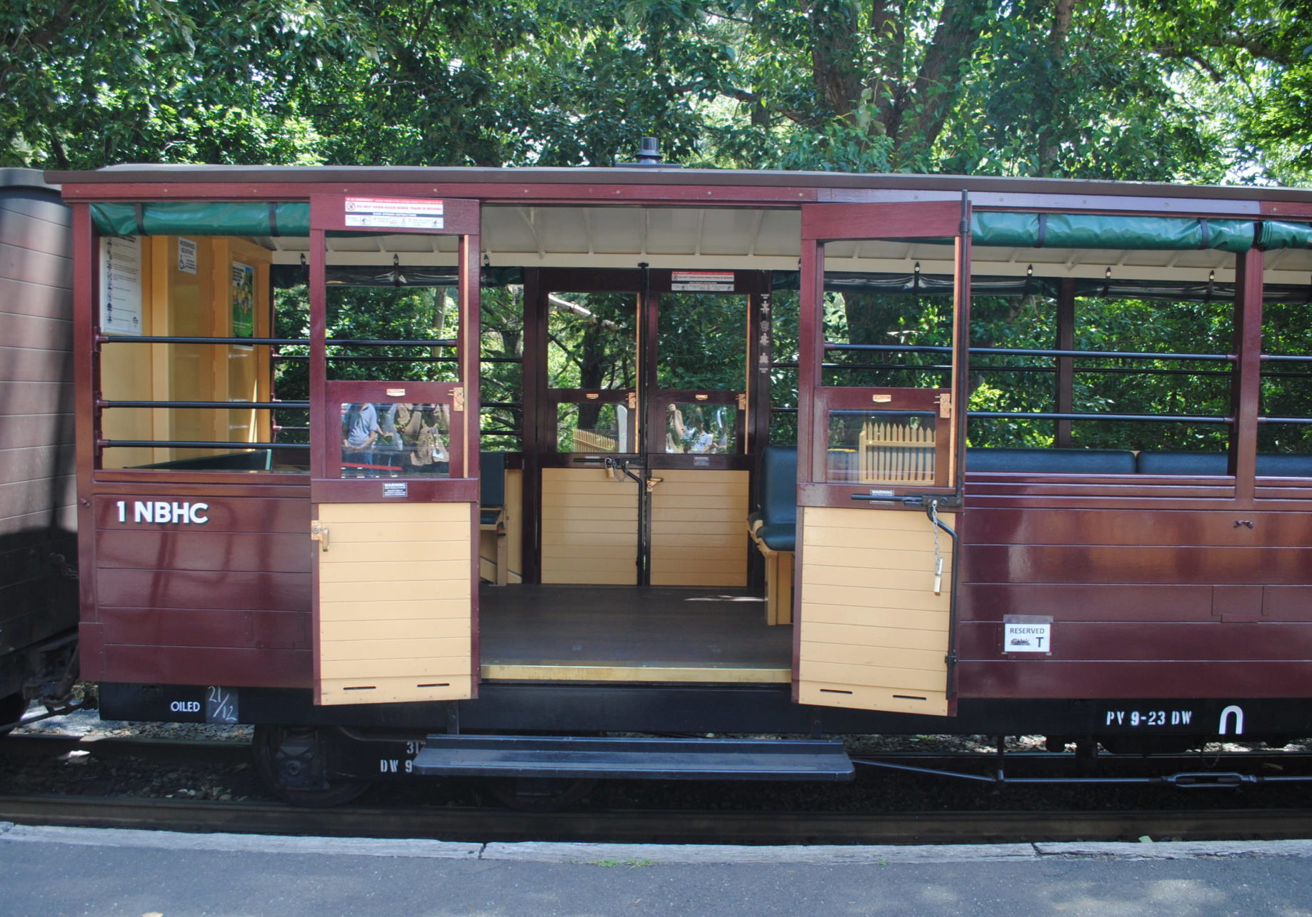Accessible carriage with double doors. The doors are open and the carriage is located at a Puffing Billy platform.