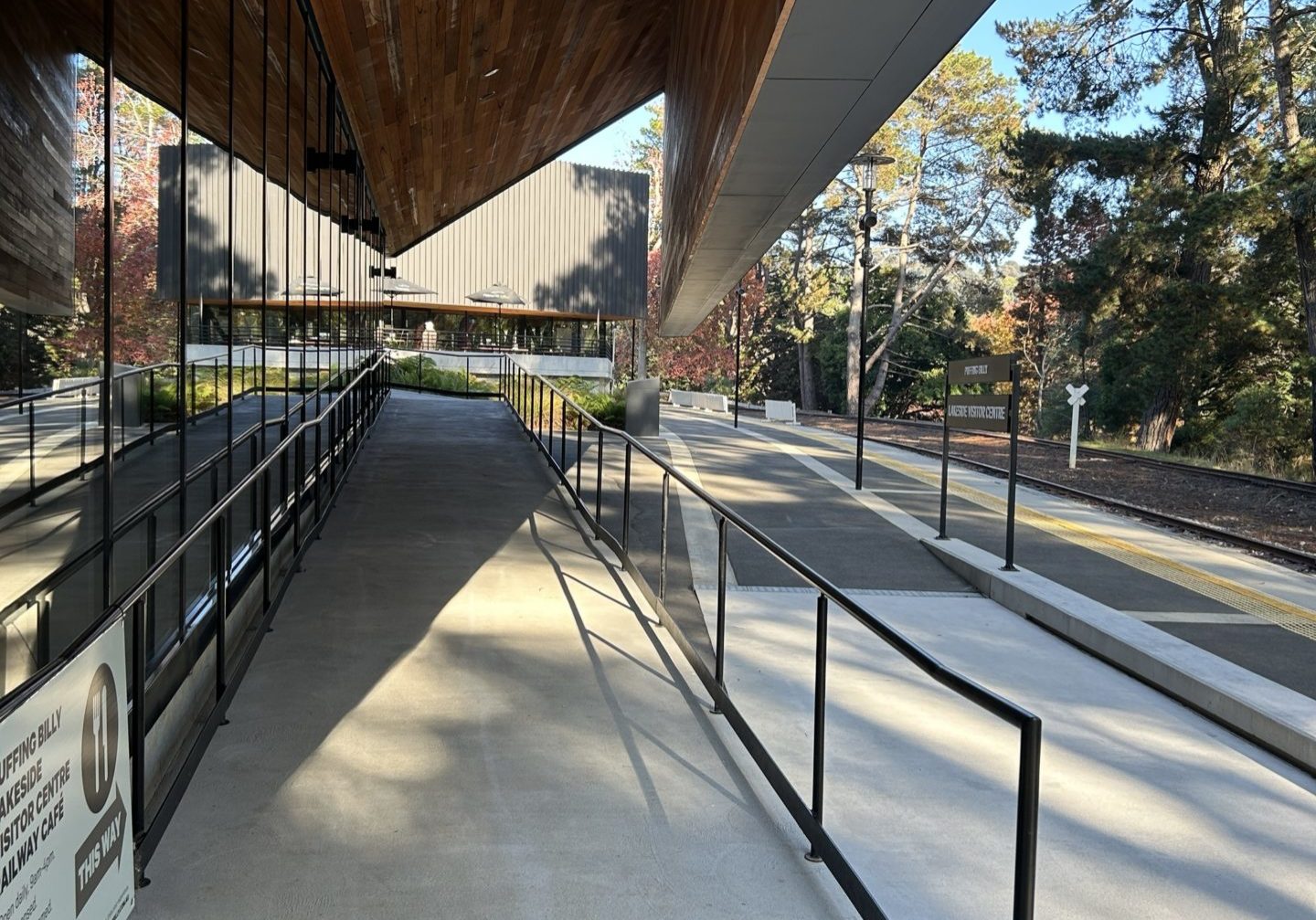 Ramp up to an alfresco deck. A train platform is located adjacent to the ramp.