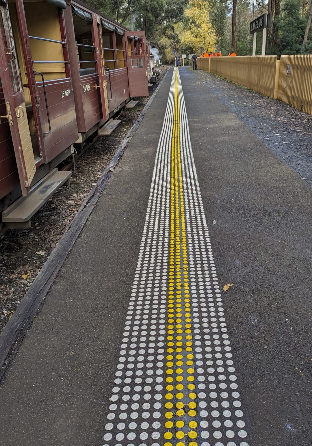 Tactile Ground Surface Indicators At Puffing Billy's Lakeside Station Platform With Open Side Carriages Visible.